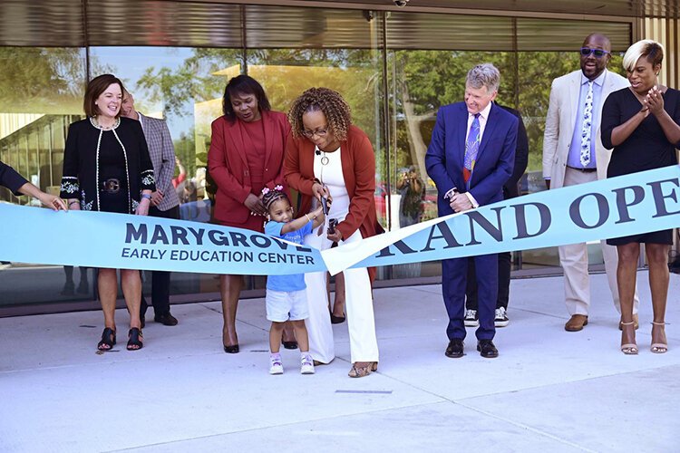 Marygrove Early Education Center director Celina Byrd and a student, Ariyah Reid, cut the ribbon officially opening the new facility.