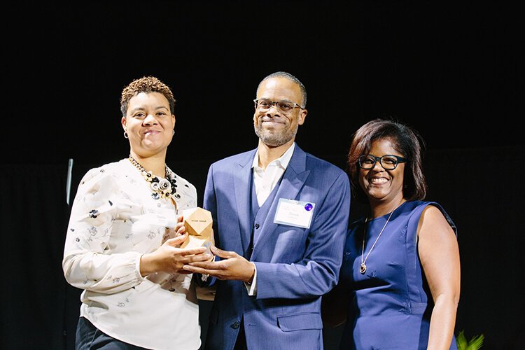 Pam Lewis, right, presents The Small Business Champion award to Tosha Tabron and Derek Edwards of Invest Detroit last year. Lewis is the first recipient of this year's Marlowe Stoudamire Small Business Champion Award.