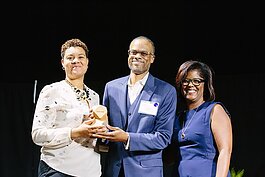 Pam Lewis, right, presents The Small Business Champion award to Tosha Tabron and Derek Edwards of Invest Detroit last year. Lewis is the first recipient of this year's Marlowe Stoudamire Small Business Champion Award.