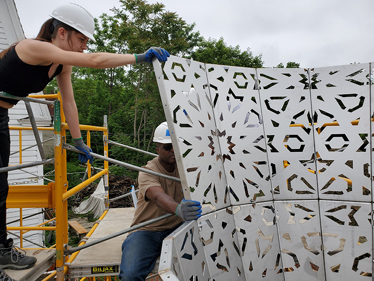 SUNY Purchase College Alum Kat Ermant working with OAAC Artist Jide Aje on the American Riad.