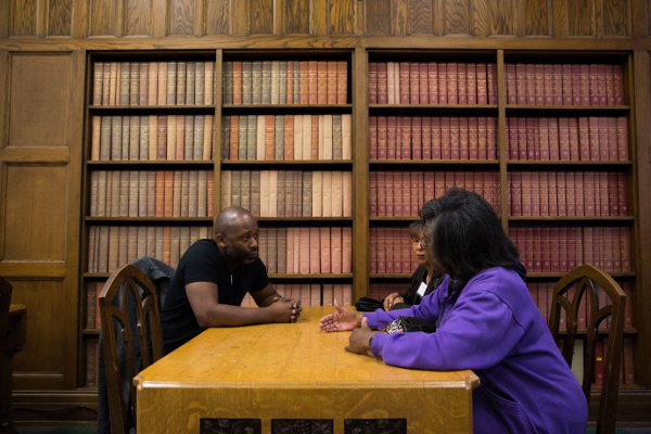 Theaster Gates converses with neighborhood residents in the library of Marygrove College