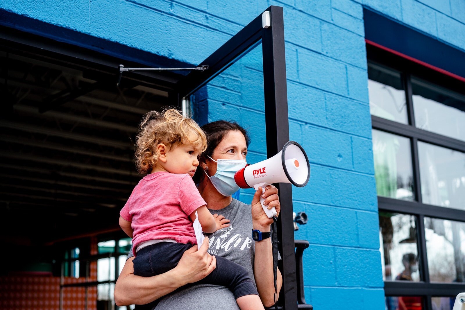 Gwen Meyer shouts out an order on a megaphone. Coriander Kitchen and Farm. Photo by Nick Hagen