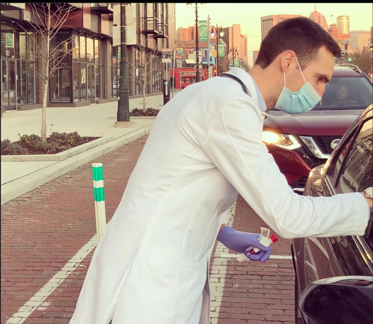 Dr. Paul Thomas administers a COVID-19 vaccine to a drive-thru patient.