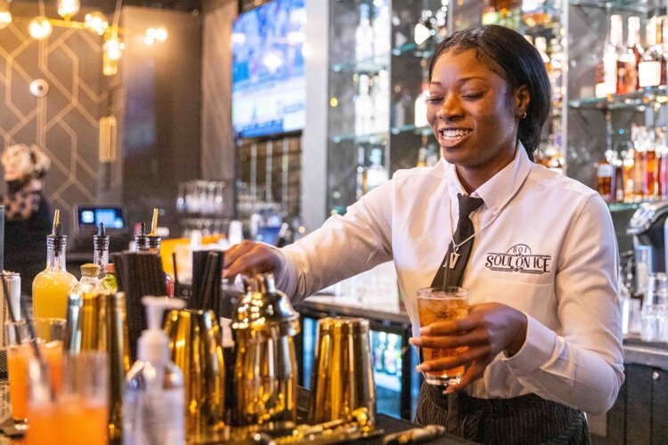 Bartender mixing a craft cocktail at Soul on Ice, located in Detroit's Midwest neighborhood.