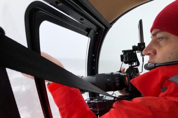 Aerotronic CEO Chris Chance surveys utility poles from a helicopter.