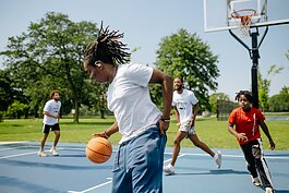 People play basketball during a Pistons Neighbors program session in Rouge Park.