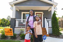 Dayton, Jamillyah, and Dallas Palmer outside their new home in Pontiac.