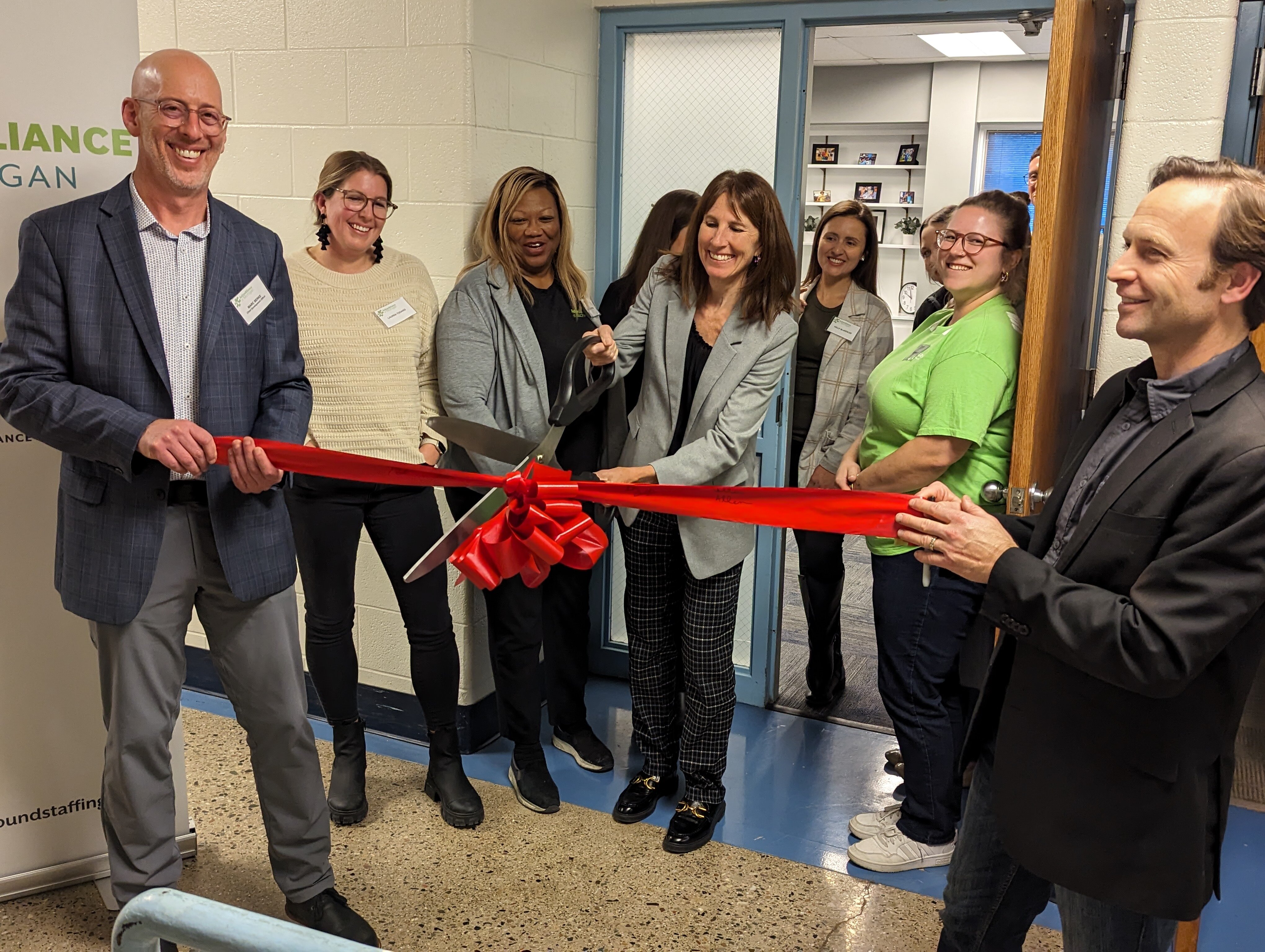 Dr. Colleen Allen, AAoM president and CEO cuts the ribbon.