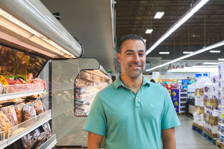 Vincent Nona stands in the Parkway Foods store.
