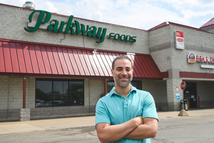 Vincent Nona stands in front of Parkway Foods.