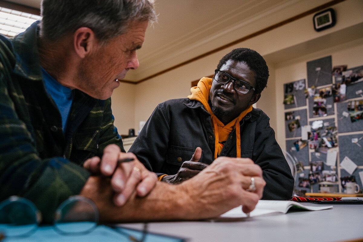 Instructor Kevin Gordon helps Serigne Lo, an ESL student from Senegal, study language needed for a driver's exam