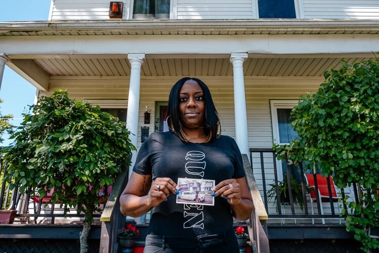 Jeanine holds a photo of her grandmother in front of her house in 1965.