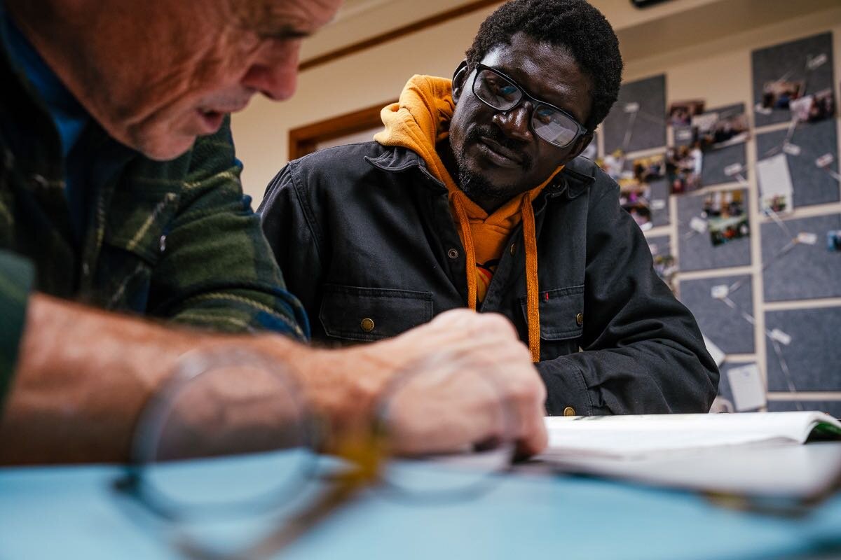 Instructor Kevin Gordon helps Serigne Lo, an ESL student from Senegal, study language needed for a driver's exam